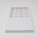 A white rectangular plate with numerous rectangular cutouts sits on a white surface.