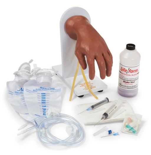 A training hand model displays intravenous insertion; surrounding it are IV bags, tubing, syringes, needles, and artificial blood.