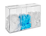 A clear acrylic box holds piles of white and light blue disposable coverings; it's likely a dispenser in a clinical or sanitary setting.