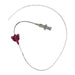 A medical catheter is coiled in a white space, featuring a purple butterfly clip at one end, a clear hub in the middle, and markings along its length.