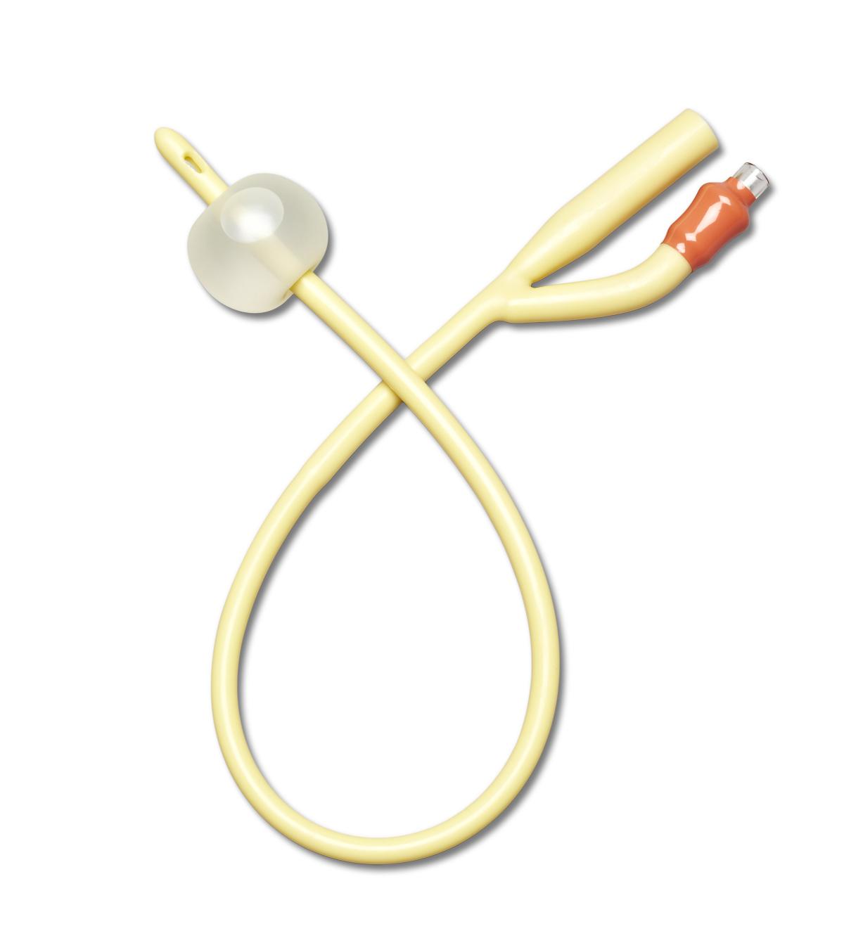 A pale yellow Foley catheter lies on a white background. The catheter is curved into a loose loop, showing its dual lumen and balloon.