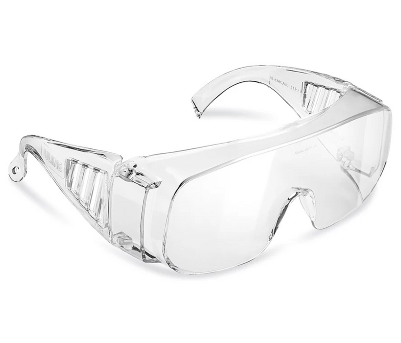 Clear safety glasses rest on a white background. The glasses are designed to protect the eyes.