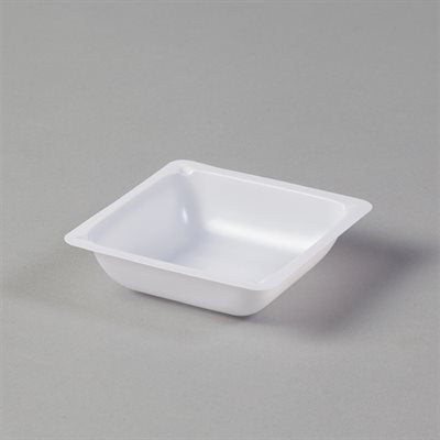 A small, square, white plastic dish sits on a gray surface.